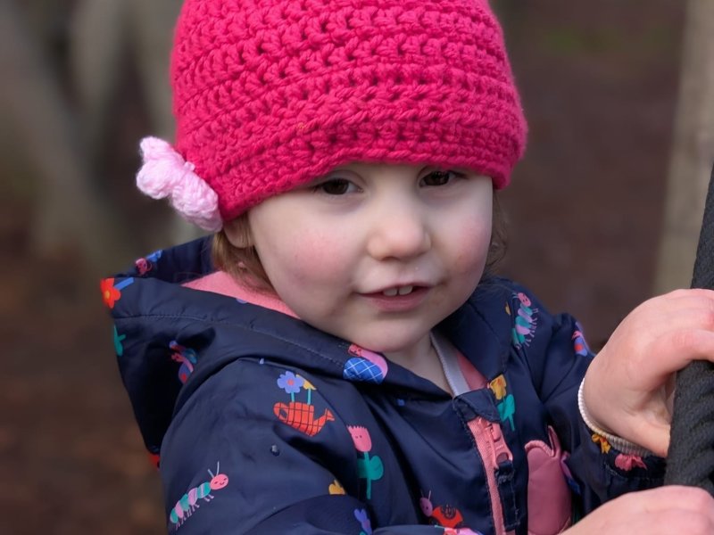 Customer wearing a custom crocheted hat